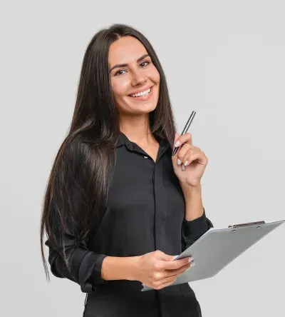 Smiling professional woman holding a clipboard and pen, representing a career in health information management.