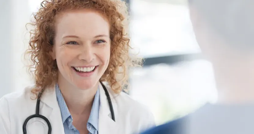 Public health nurse with DNP smiling with RN in hospital